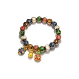 Женский браслет с бусинами "Поглощающий зверь" золотого цвета